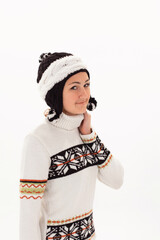 Portrait of a Caucasian girl in a warm hat and knitted sweater on a white background