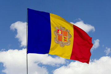 Andorra flag isolated on the blue sky background. close up waving flag of Andorra. flag symbols of Andorra. Concept of Andorra.