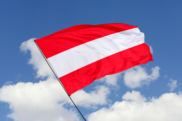 Austria flag isolated on the blue sky background. close up waving flag of Austria. flag symbols of Austria. Concept of Austria.