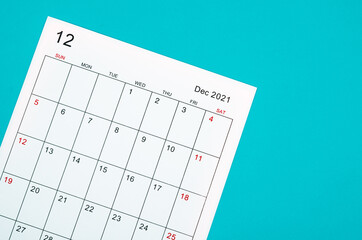 December 2021 calendar sheet on green background.