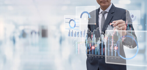 Smart businessman using virtual digital tablet analyzing financial data, economic graph growth chart with blurred office background, Business strategy, plan and solution