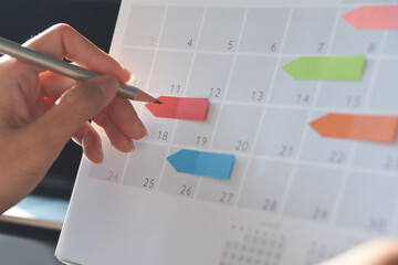 Event planner timetable agenda plan on organize schedule event. Business woman using mobile phone...