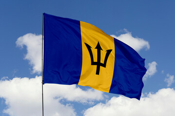 Barbados flag isolated on the blue sky background. close up waving flag of Barbados. flag symbols of Barbados. Concept of Barbados.
