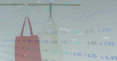 Image of numbers changing and statistics recording over two shopping bags