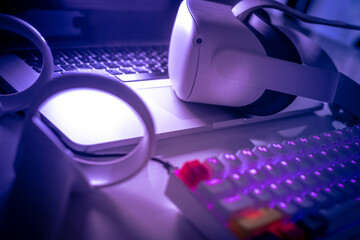 Virtual reality devices on the desk. Laptop VR 3D viewer air joystick and multimedia keyboard. Cyberpunk futuristic mood immersive experience with new video game tech Next-generation electronic device