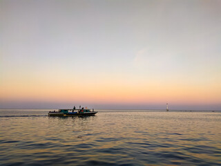 A Boat Sailing Over The Sea With Colorful Horizon