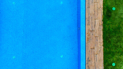 Aerial. Swimming pool fragment in landscape design. Top view from drone.