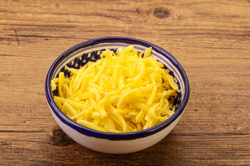 Shredded yellow cheese in the bowl
