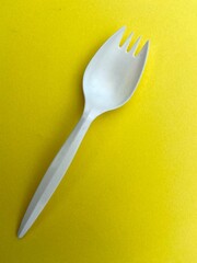 plastic single use disposable cutlery fork on bright background with copy space 