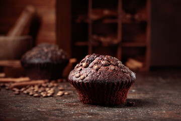 Chocolate muffins on a brown background.