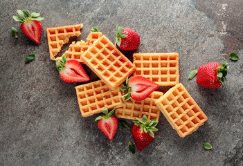 Waffles with juicy strawberries.