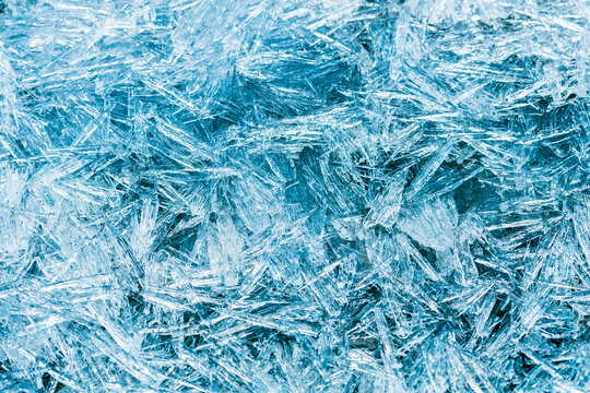 natural background from ice needles. toned image in blue