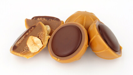 Group of caramel cup candies filled with hazelnuts, creamy nougat and topped with dark chocolate