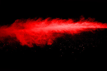 abstract red powder explosion on black background.abstract red powder splatted on black background....