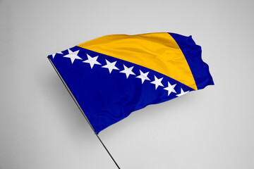 Bosnia and Herzegovina flag isolated on white background. close up waving flag of Bosnia and Herzegovina. flag symbols of Bosnia and Herzegovina. Concept of Bosnia and Herzegovina.