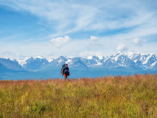 Man solo traveler hiking in mountains, adventure solo traveling lifestyle concept, active weekend vacations on the wild nature.