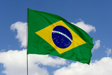 Brazil flag isolated on the blue sky background. close up waving flag of Brazil. flag symbols of Brazil. Concept of Brazil.
