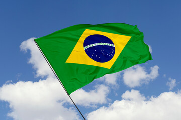 Brazil flag isolated on the blue sky background. close up waving flag of Brazil. flag symbols of Brazil. Concept of Brazil.