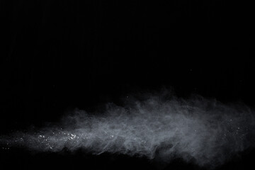 Fototapeta na wymiar White powder explosion on black background. Colored cloud. Colorful dust explode. Paint Holi.