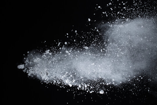 White powder explosion on black background. Colored cloud. Colorful dust explode. Paint Holi.