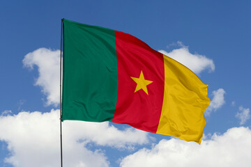 Cameroon flag isolated on the blue sky background. close up waving flag of Cameroon. flag symbols of Cameroon. Concept of Cameroon.