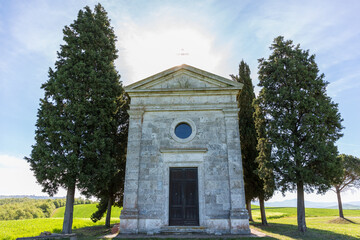 Chapel in backlight on a hill in the countryside