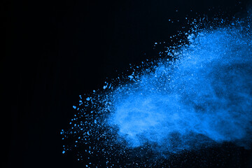abstract blue powder splatted background,Freeze motion of color powder exploding/throwing color powder,color glitter texture on black background.