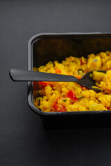 Kaanda poha in the black container, a Maharashtrian snacks consumed in the morning.