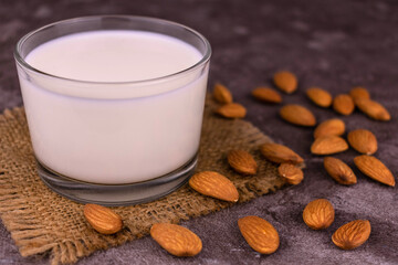 Almond milk in a transparent jug on a white background.