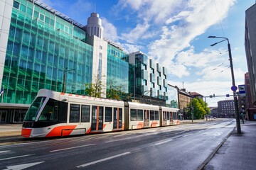 Modern Tallinn city tram in its new part of glass buildings.