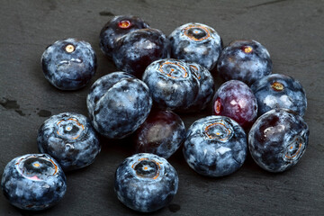 Close up of fresh ripe juicy blueberries laid on a slate serving platter