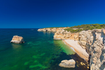 Fototapeta premium Aerial views of Praia da Marinha and Malhada do Baraco - beaches in Algarve, Portugal
