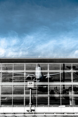 airplane reflection in terminal building windows