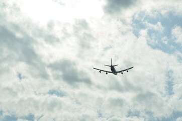 Fototapeta na wymiar Airplane in the cloudy sky