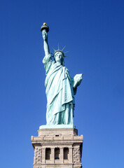 Fototapeta premium Statue of Liberty in New York isolated against a deep blue sky. No people. Copy space.