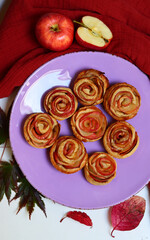 Apple cakes on a table. Close up photo of sweet homemade tarts with cinnamon, honey and apple filling. Autumn desserts ideas. 