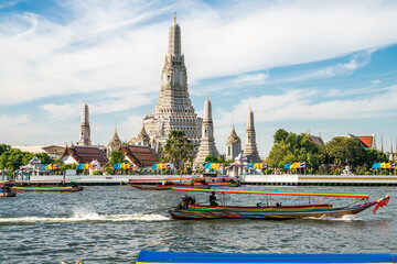 Travel boat in Chao phra Ya river background with temple of dawn