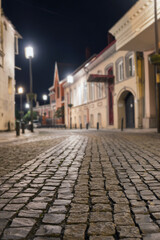  Night view of a cobblestone street in old district, selective focus