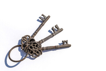 Three old keys on a white background