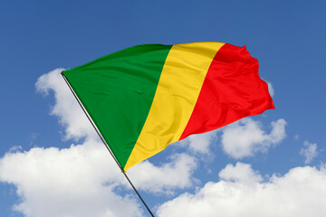 Congo flag isolated on the blue sky background. close up waving flag of Congo. flag symbols of Congo. Concept of Congo.