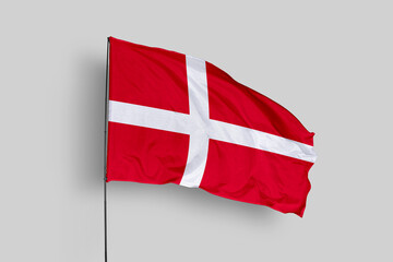 Denmark flag isolated on the blue sky background. close up waving flag of Denmark. flag symbols of Denmark. Concept of Denmark.