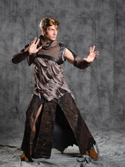 Steampunk or post-apocalyptic style character, a young man in a grunge suit.