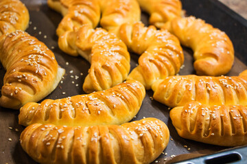 Bagels with sesame seeds on a baking sheet