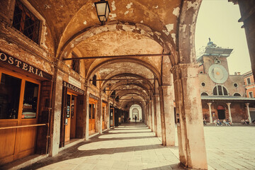 Arches of historical square with bars and restaurants of beautiful european city Venice.