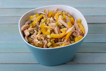 Rustikaler Wurstsalat mit gelbem Paprika im blauer Bowl