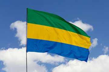 Gabon flag isolated on the blue sky background. close up waving flag of Gabon. flag symbols of Gabon. Concept of Gabon.