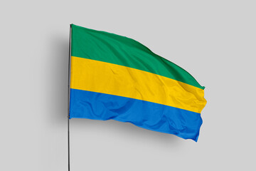 Gabon flag isolated on the blue sky background. close up waving flag of Gabon. flag symbols of Gabon. Concept of Gabon.