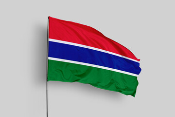 Gambia flag isolated on the blue sky background. close up waving flag of Gambia. flag symbols of Gambia. Concept of Gambia.