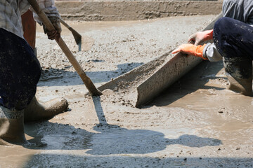worker team holding mixer cement truck pour fluid concrete tube to  floor house . Group of worker...