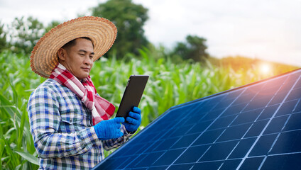Fototapeta premium Concept : Green and clean power technology for environment use in agriculture. Asian male farmer checking solar panel at his garden.